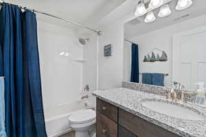 Full bath featuring shower / bathtub combination with curtain and vanity