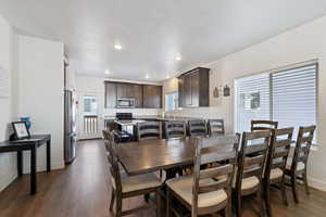 Dining area with plenty of natural light, dark wood-type flooring, and recessed lighting