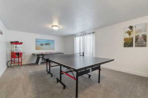 Playroom with carpet and a textured ceiling