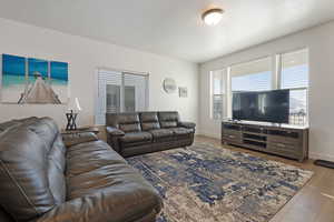 Living area featuring wood finished floors and a textured ceiling