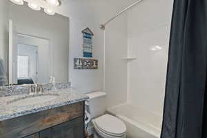 Bathroom with vanity and shower / tub combo with curtain