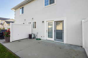 Back of property with a patio and stucco siding