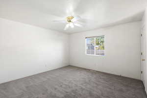 Unfurnished room with carpet flooring and a ceiling fan