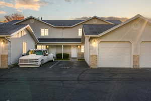 Traditional-style home with stucco siding and roof with shingles