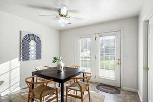 Dining area featuring a ceiling fan and baseboards