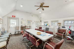 Dining area featuring dark carpet, vaulted ceiling, recessed lighting, and ceiling fan