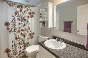 Full bathroom featuring vanity and a shower with curtain