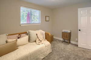 Bedroom featuring light colored carpet and baseboards