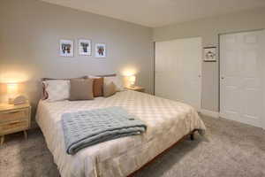 Bedroom with carpet flooring and multiple closets