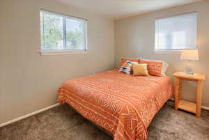 Carpeted bedroom featuring baseboards