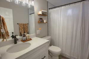 Full bathroom featuring vanity and curtained shower