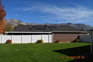 Fenced backyard featuring a mountain view