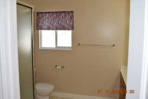 Full bathroom featuring vanity, a shower stall, and light tile patterned flooring