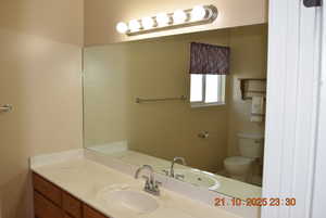 Half bath with vanity and toilet
