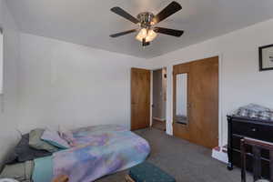 Upstairs bedroom #2 featuring ceiling fan and a closet