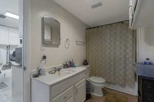Basement Full bath with vanity, light tile patterned floors, and shower / bath combo