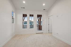 Spare room with light carpet and recessed lighting