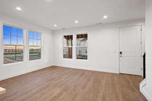 Empty room with recessed lighting and wood finished floors