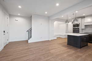 Kitchen with decorative backsplash, recessed lighting, dark wood-style flooring, appliances with stainless steel finishes, and decorative light fixtures