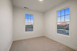 Empty room with carpet and baseboards