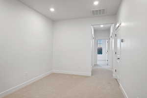 Unfurnished room featuring light carpet and recessed lighting
