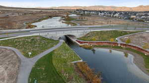 Aerial perspective of suburban area featuring a notable bridge and a water and mountain view