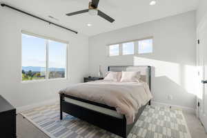 Bedroom featuring light colored carpet, ceiling fan, and recessed lighting