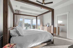 Bedroom featuring carpet floors, a ceiling fan, ensuite bathroom, and access to outside
