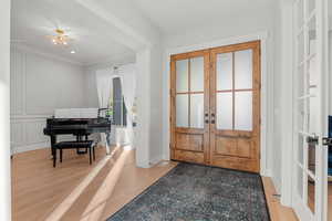 Foyer entrance featuring french doors, light wood-type flooring, and recessed lighting