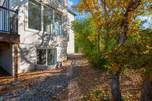 View of property exterior featuring stucco siding and a chimney