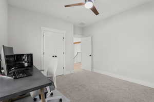 Office space featuring light carpet and ceiling fan