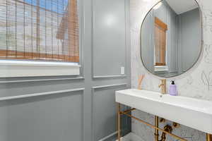 Bathroom featuring wallpapered walls