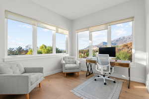 Home office with light wood-style floors and baseboards