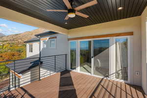 Deck with a ceiling fan and a mountain view