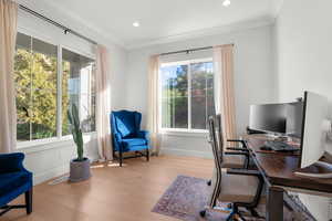 Office space with light wood finished floors, recessed lighting, and ornamental molding