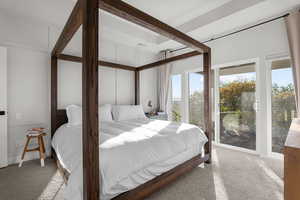 Bedroom with carpet and access to outside