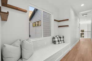 Hall featuring wood finished floors and recessed lighting