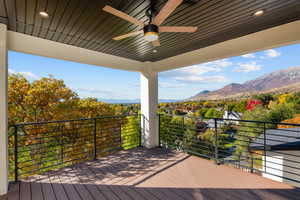 Wooden deck featuring a ceiling fan and a mountain view