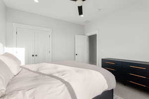 Bedroom featuring light carpet, a ceiling fan, recessed lighting, and a closet