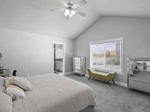 Carpeted bedroom with ceiling fan, ensuite bathroom, and high vaulted ceiling