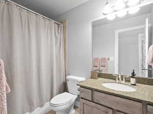Bathroom with vanity and shower / bathtub combination with curtain