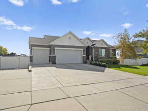 Craftsman house with board and batten siding, driveway, a garage, a shingled roof, and brick siding