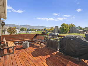Wooden deck featuring a grill and a mountain view