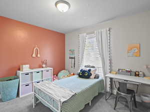 Carpeted bedroom featuring a textured ceiling