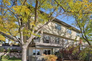 Rear view of property with brick siding