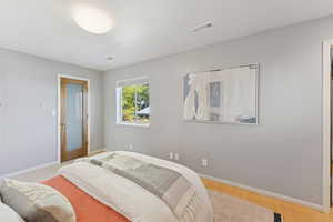 Bedroom featuring light wood-style flooring and baseboards