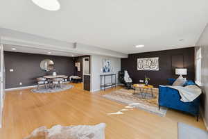 Living area with light wood-style flooring and recessed lighting