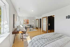 Bedroom featuring light wood-style flooring and a spacious closet