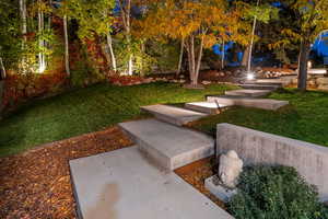 View of grassy yard featuring a patio