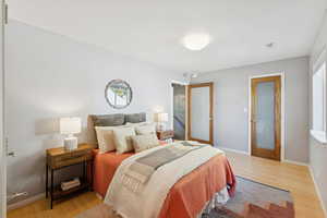 Bedroom featuring light wood-style flooring and baseboards